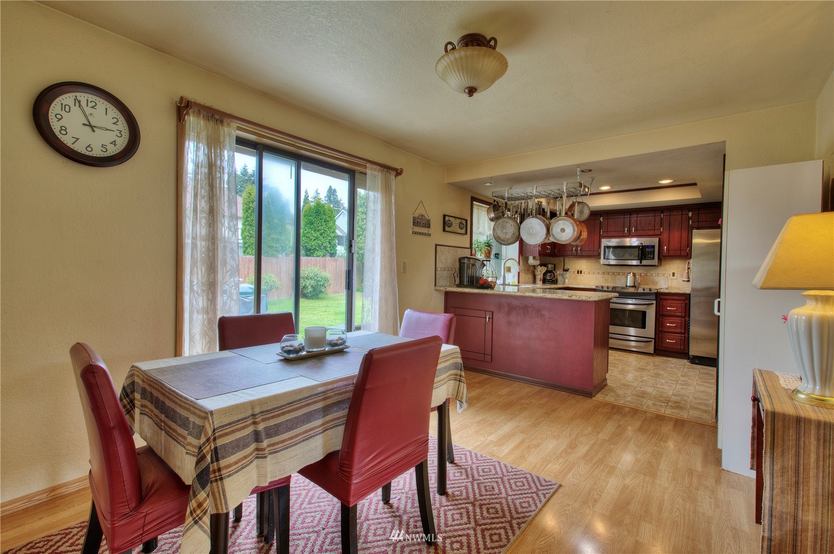 9216 South 239th Street Kent, WA 98031 - Photo 9 of 20 a view of a dining room with furniture window and wooden floor