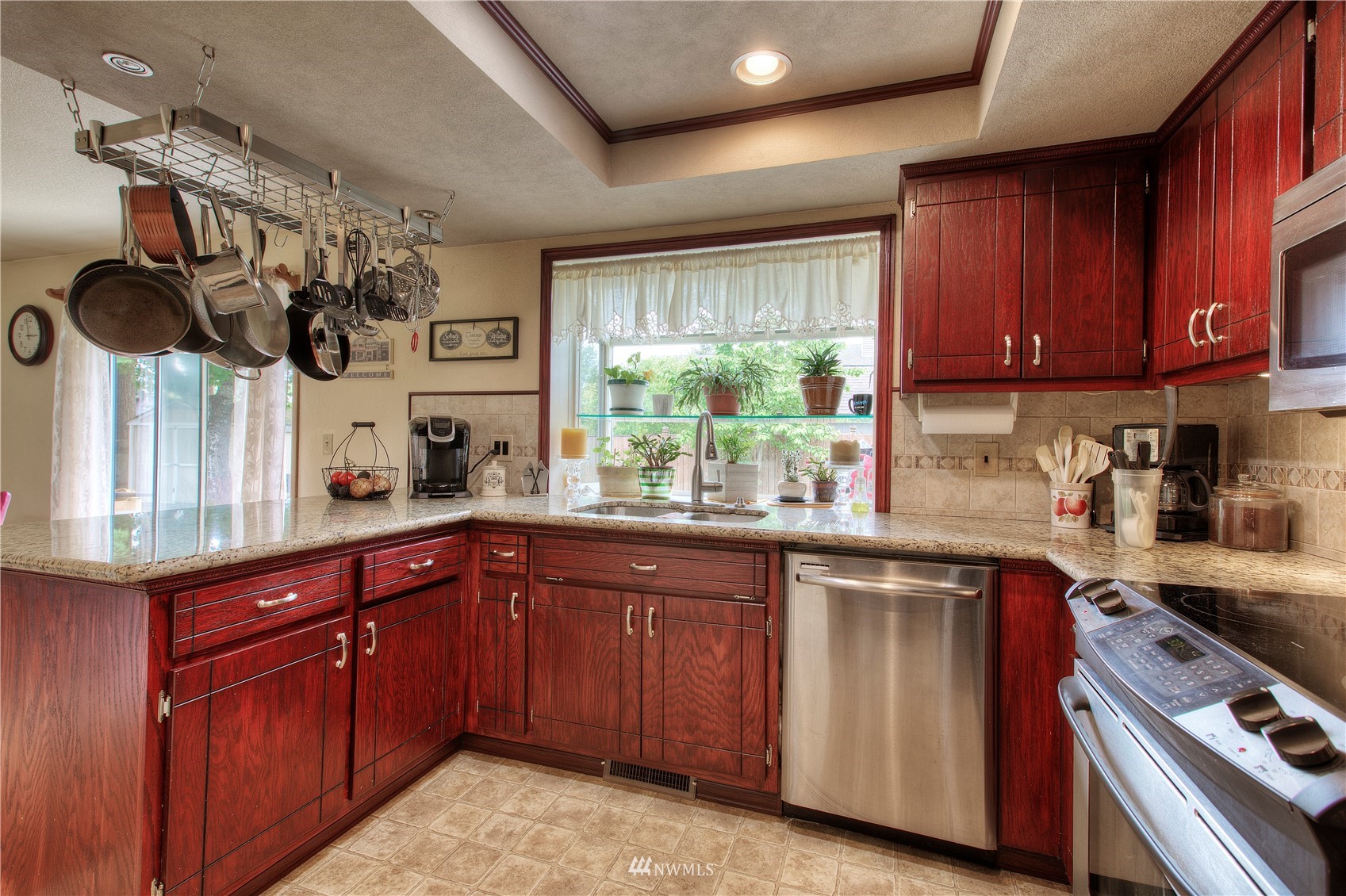 9216 South 239th Street Kent, WA 98031 - Photo 10 of 20 a kitchen with stainless steel appliances granite countertop wooden cabinets and a stove