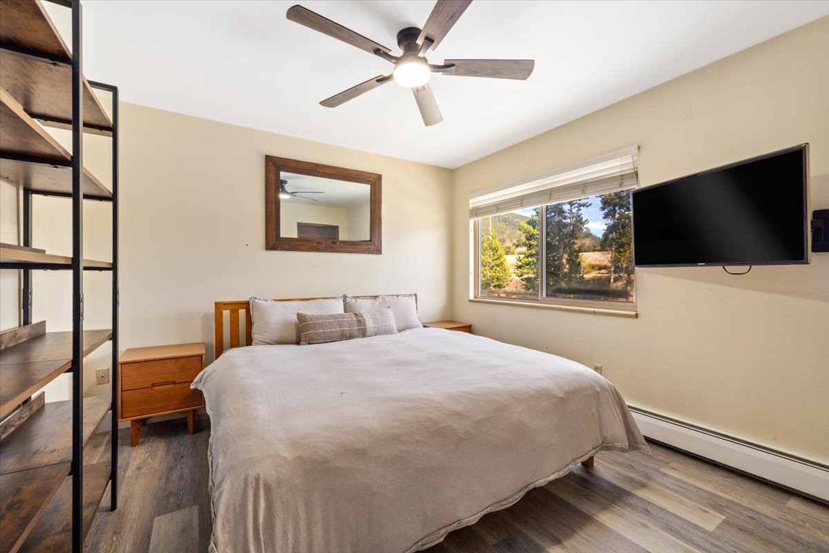 110 Evergreen Road, Unit 301 Dillon, CO 80435 - Photo 15 of 23 a bedroom with a bed and a flat screen tv