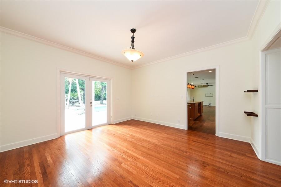 2730 Cardinal Circle Gulf Stream, FL 33483 - Photo 12 of 35 a view of an empty room with wooden floor and a window