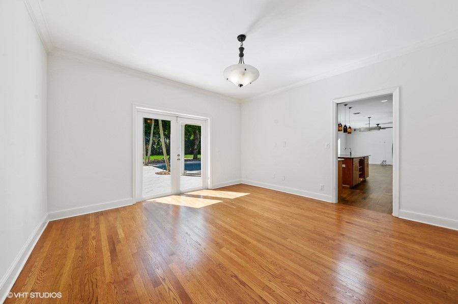 2730 Cardinal Circle Gulf Stream, FL 33483 - Photo 13 of 35 a view of an empty room with wooden floor and a window
