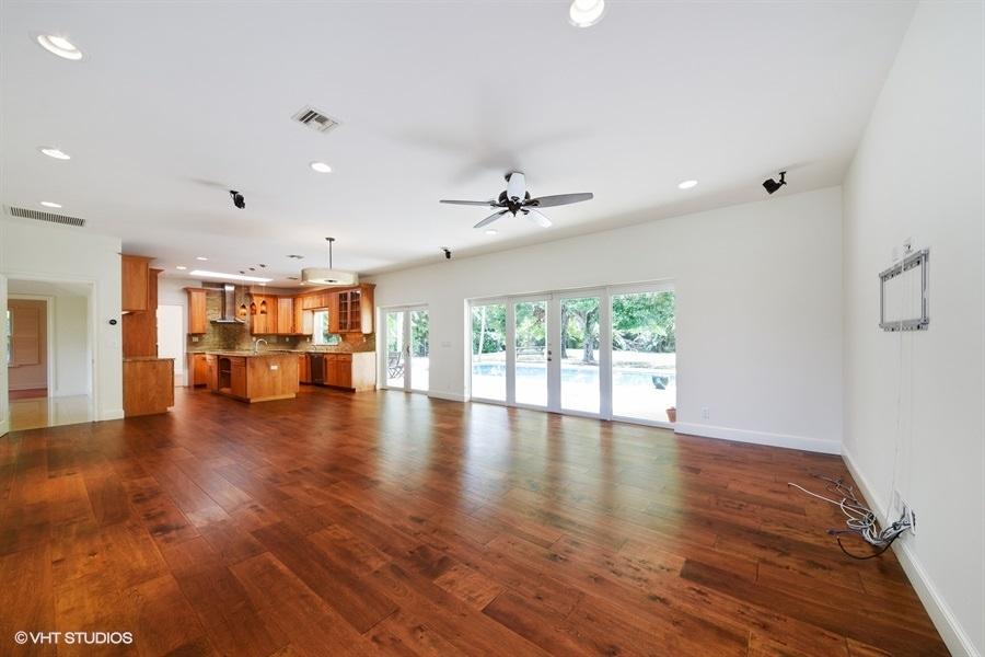 2730 Cardinal Circle Gulf Stream, FL 33483 - Photo 16 of 35 a view of an empty room with wooden floor and a window