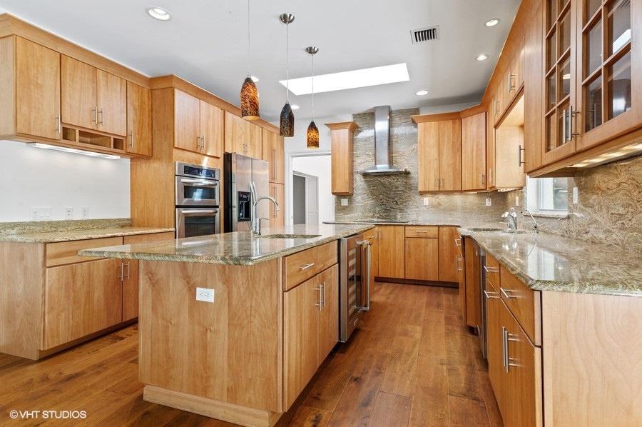 2730 Cardinal Circle Gulf Stream, FL 33483 - Photo 18 of 35 a kitchen with stainless steel appliances granite countertop a stove a sink and a refrigerator