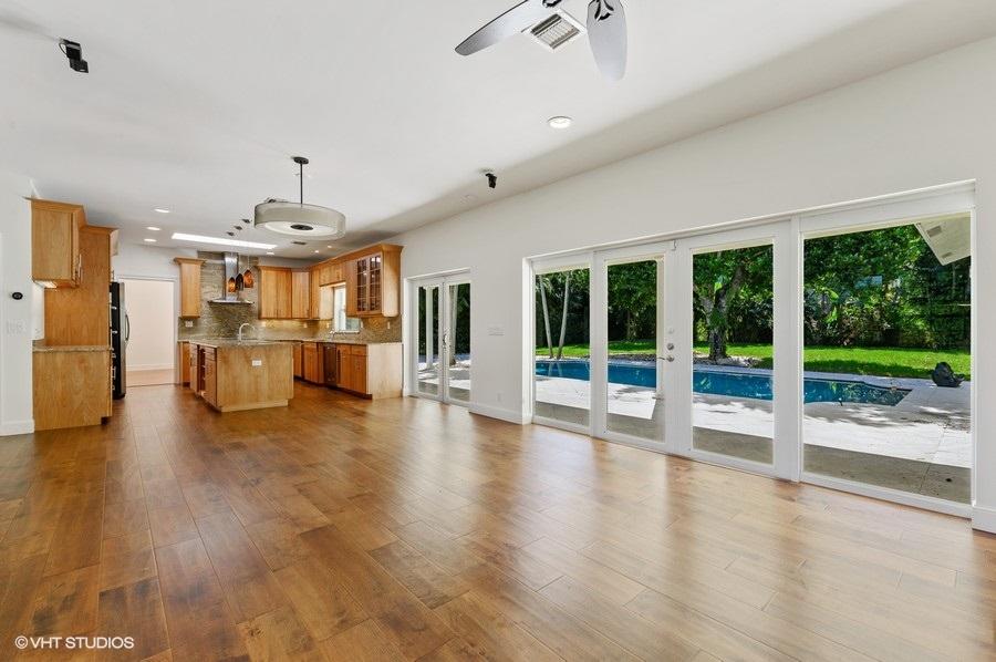 2730 Cardinal Circle Gulf Stream, FL 33483 - Photo 20 of 35 a view of a hall with wooden floor and windows