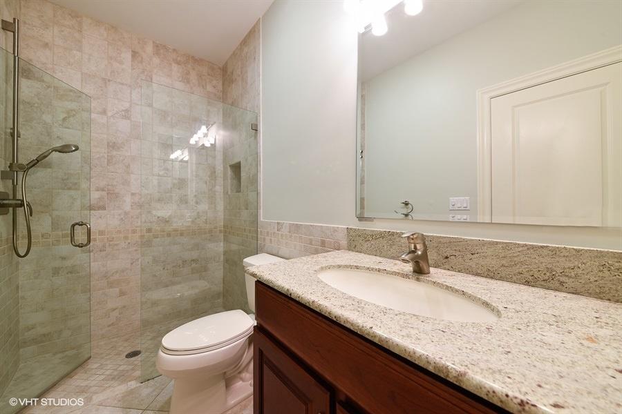 2730 Cardinal Circle Gulf Stream, FL 33483 - Photo 26 of 35 a bathroom with a granite countertop sink a toilet and shower