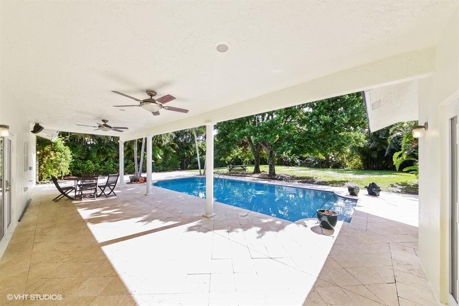 2730 Cardinal Circle Gulf Stream, FL 33483 - Photo 30 of 35 a view of a patio with a table and chairs