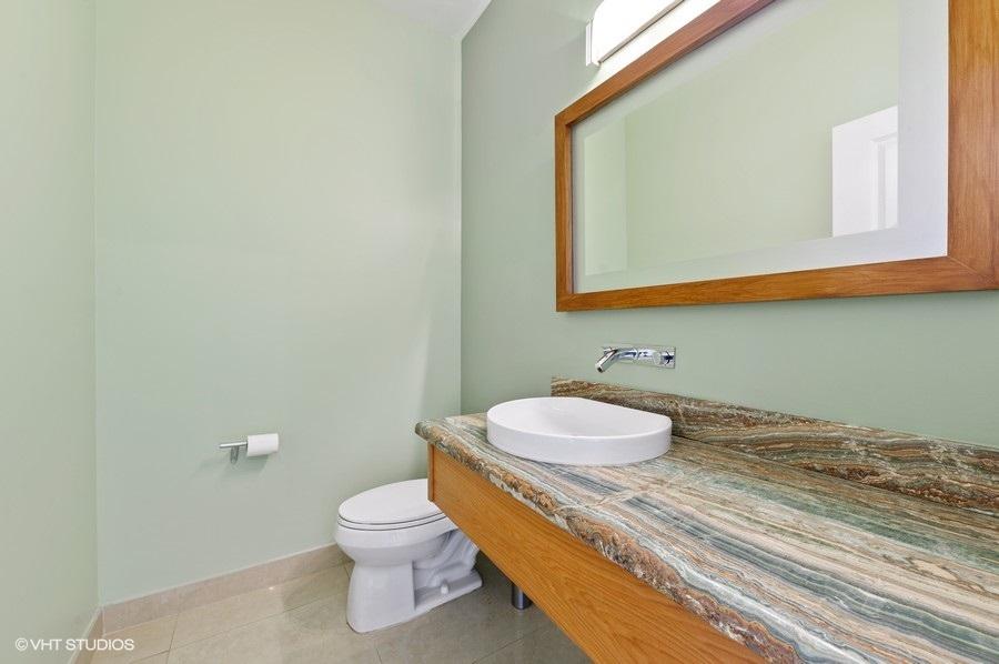 2730 Cardinal Circle Gulf Stream, FL 33483 - Photo 10 of 35 a bathroom with a toilet a sink and mirror