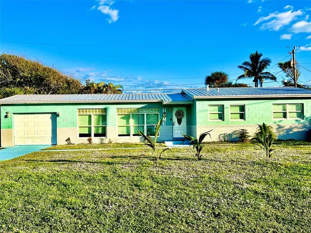 a view of swimming pool with lawn chairs and iron fence