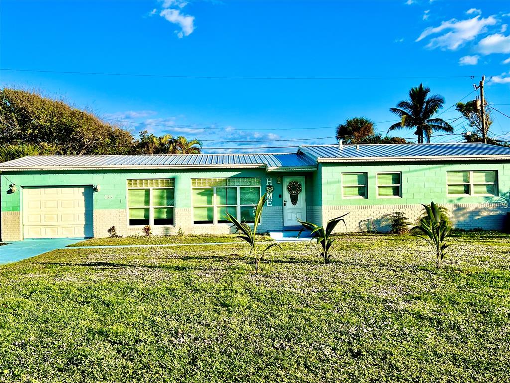 133 Northeast 1st Street Satellite Beach, FL 32937 - Photo 1 of 27 a view of swimming pool with lawn chairs and iron fence
