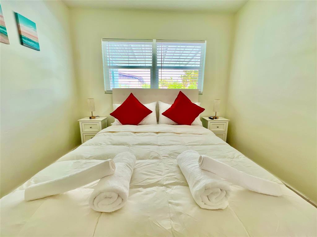 133 Northeast 1st Street Satellite Beach, FL 32937 - Photo 13 of 27 a large bed sitting in a bedroom next to a window