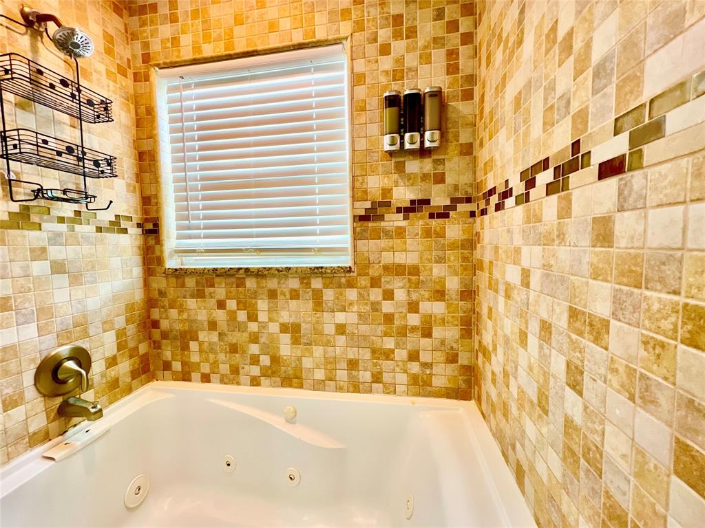 133 Northeast 1st Street Satellite Beach, FL 32937 - Photo 17 of 27 a bathroom with a bathtub and shower