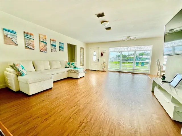 a living room with furniture and a large window
