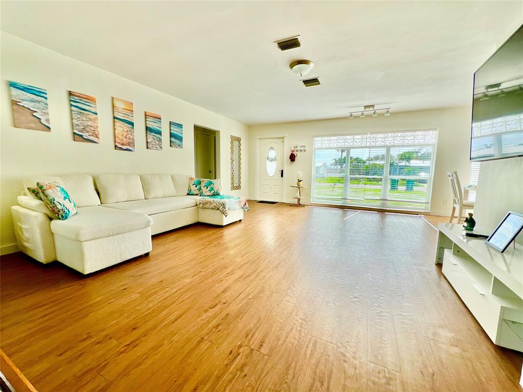 133 Northeast 1st Street Satellite Beach, FL 32937 - Photo 2 of 27 a living room with furniture and a large window