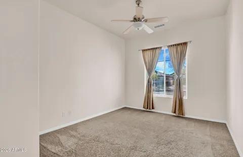 a spacious bathroom with a granite countertop sink mirror and a bathtub