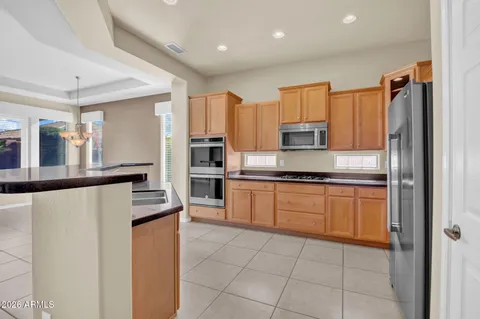 a kitchen with stainless steel appliances a refrigerator and a stove top oven