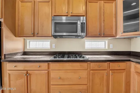 an empty room with kitchen and window