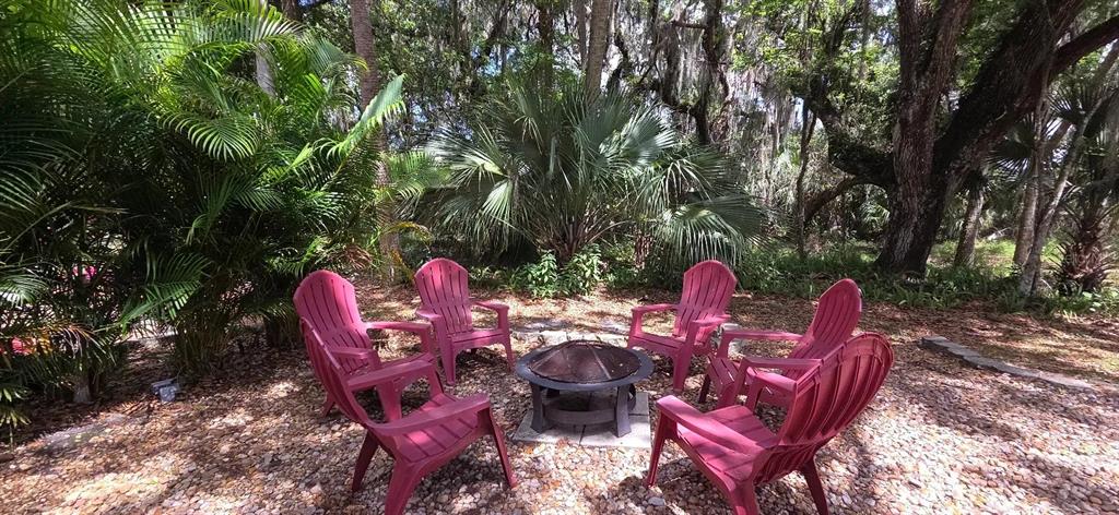 400 Longhorn Drive River Ranch, FL 33867 - Photo 2 of 10 a backyard of a house with outdoor seating