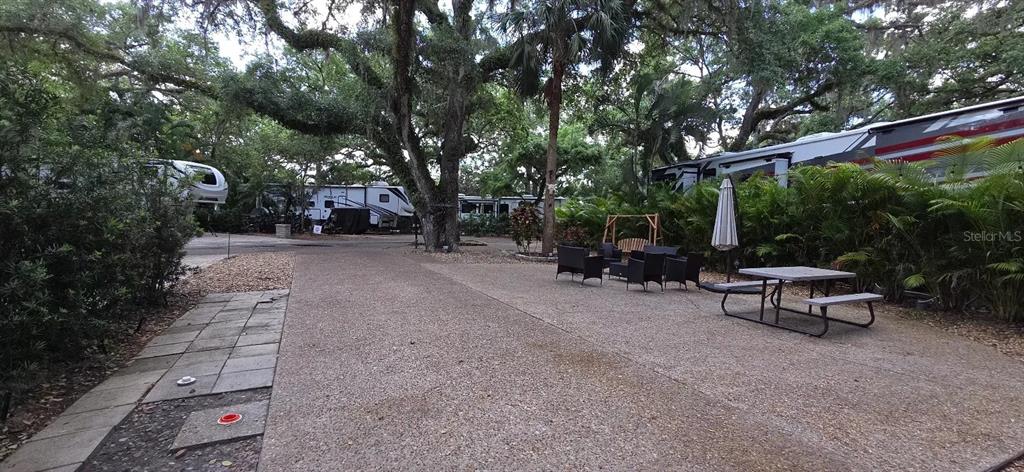 400 Longhorn Drive River Ranch, FL 33867 - Photo 10 of 10 a view of a patio with table and chairs and potted plants