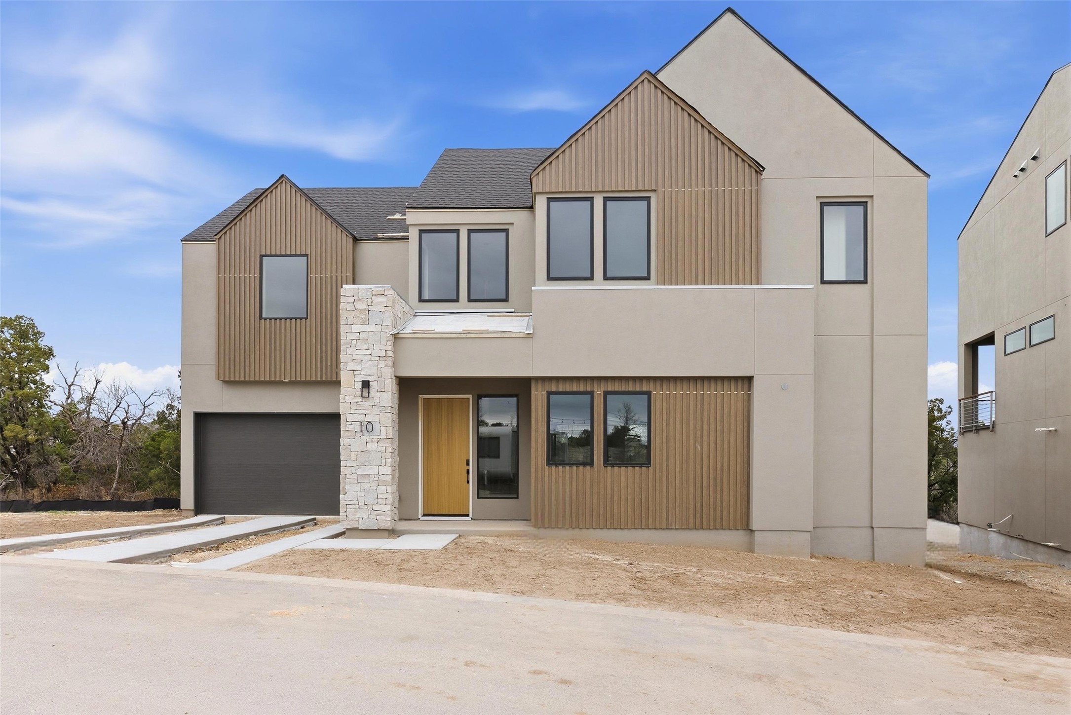 9803 Ribelin Ranch Court, Unit 10 Austin, TX 78750 - Photo 13 of 18 a front view of a house with a yard and garage