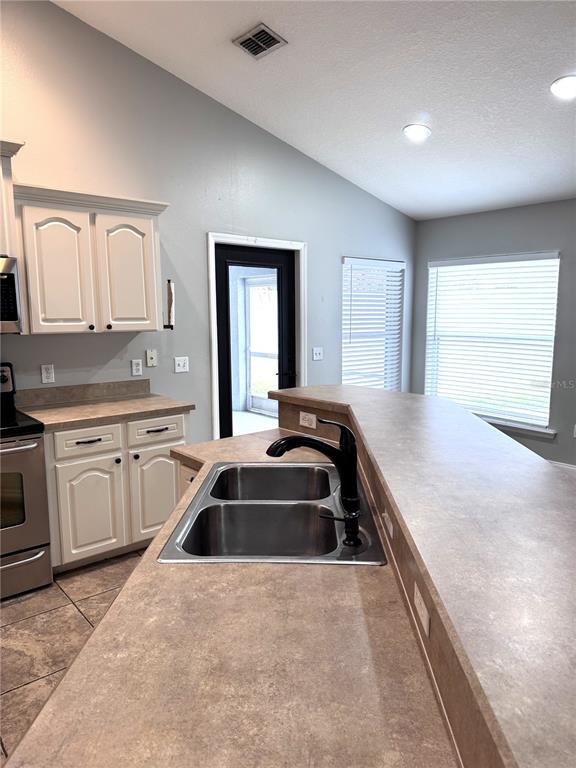 2616 Hickory View Loop Lakeland, FL 33813 - Photo 11 of 39 a kitchen that has a sink and a stove top oven
