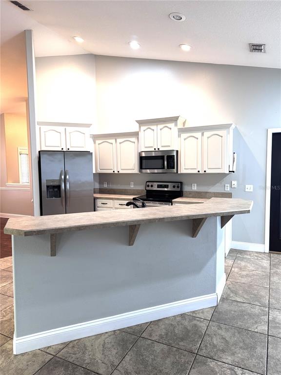 2616 Hickory View Loop Lakeland, FL 33813 - Photo 12 of 39 a kitchen with stainless steel appliances a sink and a microwave