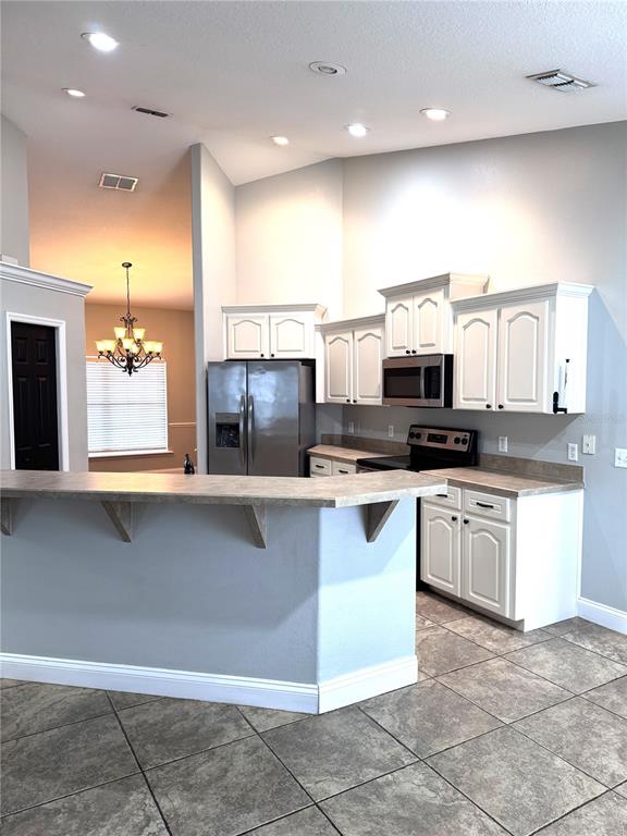2616 Hickory View Loop Lakeland, FL 33813 - Photo 16 of 39 a kitchen with stainless steel appliances a refrigerator sink and microwave
