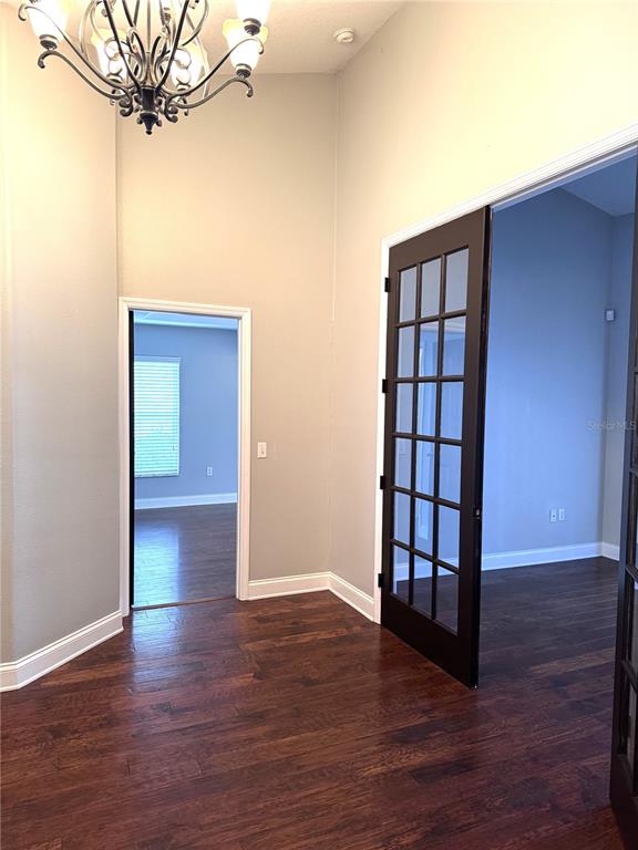 2616 Hickory View Loop Lakeland, FL 33813 - Photo 18 of 39 a view of a livingroom with wooden floor and a chandelier