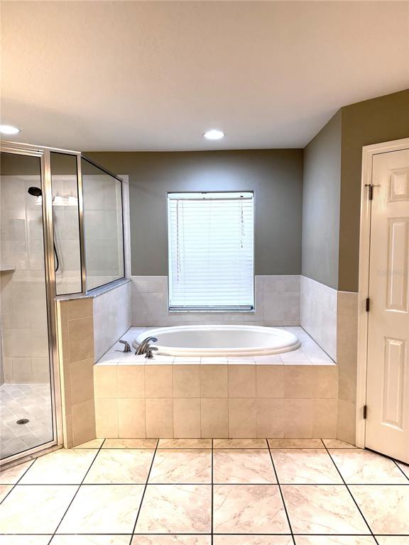2616 Hickory View Loop Lakeland, FL 33813 - Photo 22 of 39 a bathroom with a tub shower and mirror