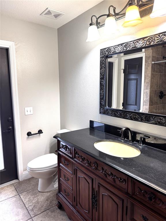 2616 Hickory View Loop Lakeland, FL 33813 - Photo 27 of 39 a bathroom with a granite countertop sink a toilet and a mirror