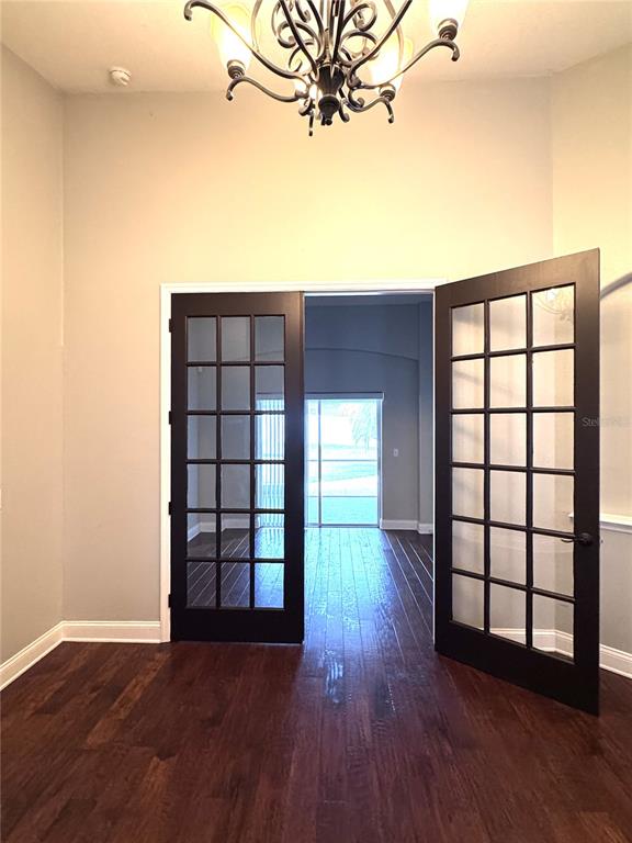 2616 Hickory View Loop Lakeland, FL 33813 - Photo 7 of 39 wooden floor in an empty room with a window