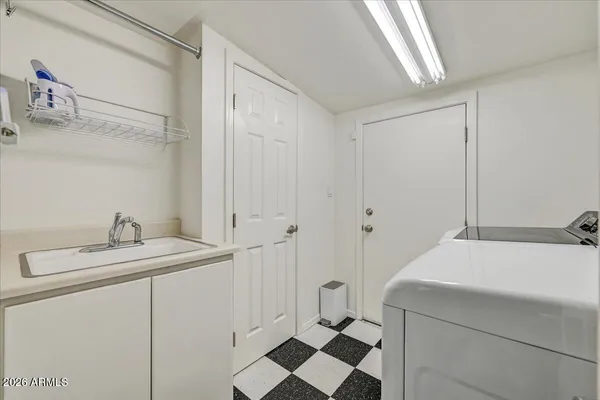 a room with a sink and cabinets