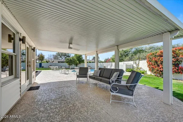 a backyard of a house with yard table and chairs