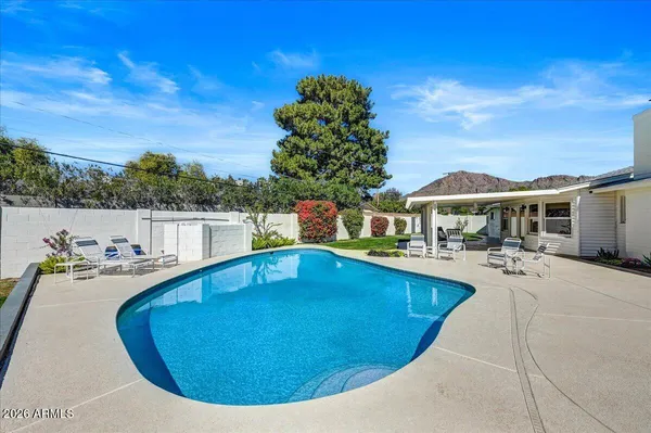 a front view of house with yard swimming pool and seating area