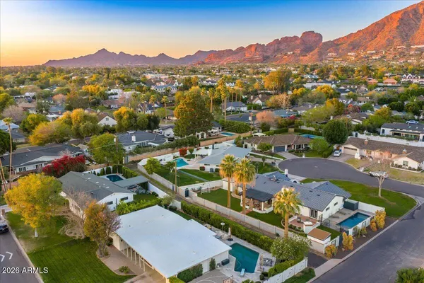 a view of a house with pool and a yard