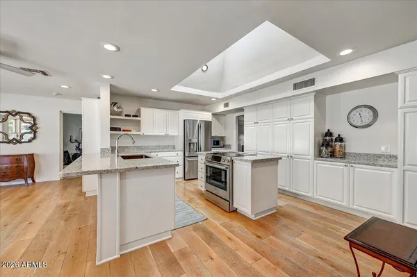 a kitchen with cabinets and wooden floor
