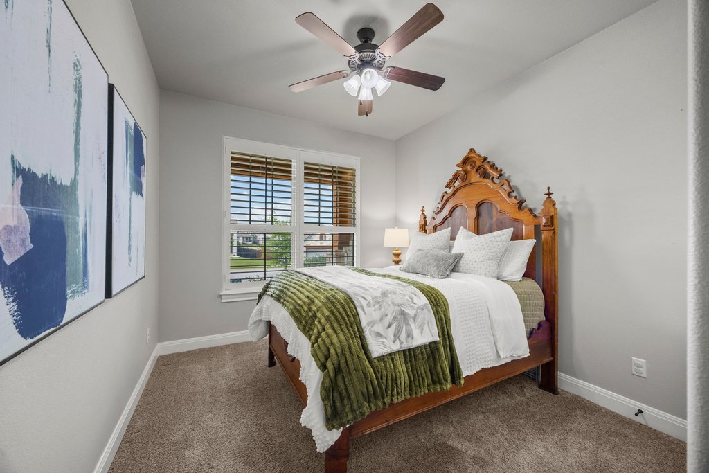 308 Morning Ridge Georgetown, TX 78628 - Photo 13 of 33 a bedroom with a bed and a ceiling fan