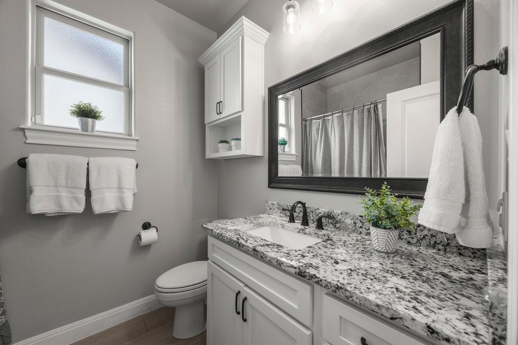 308 Morning Ridge Georgetown, TX 78628 - Photo 14 of 33 a bathroom with a granite countertop sink and a mirror
