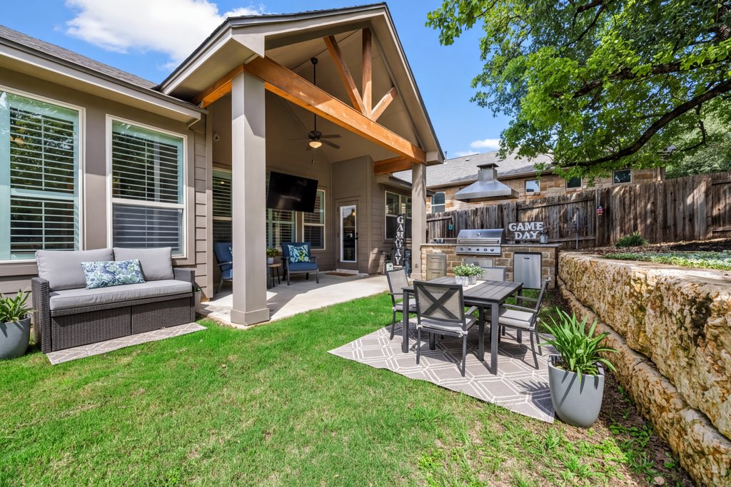 308 Morning Ridge Georgetown, TX 78628 - Photo 2 of 33 a view of a patio with table and chairs potted plants and large tree