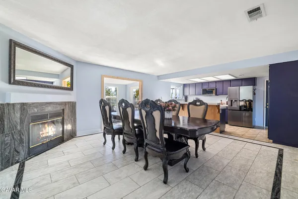 a dining room with furniture and fireplace