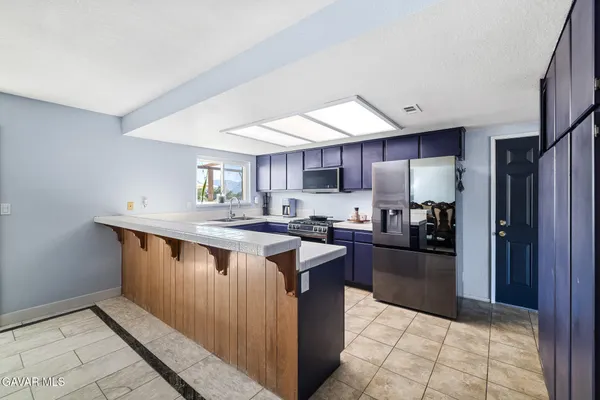a kitchen with counter top space and refrigerator