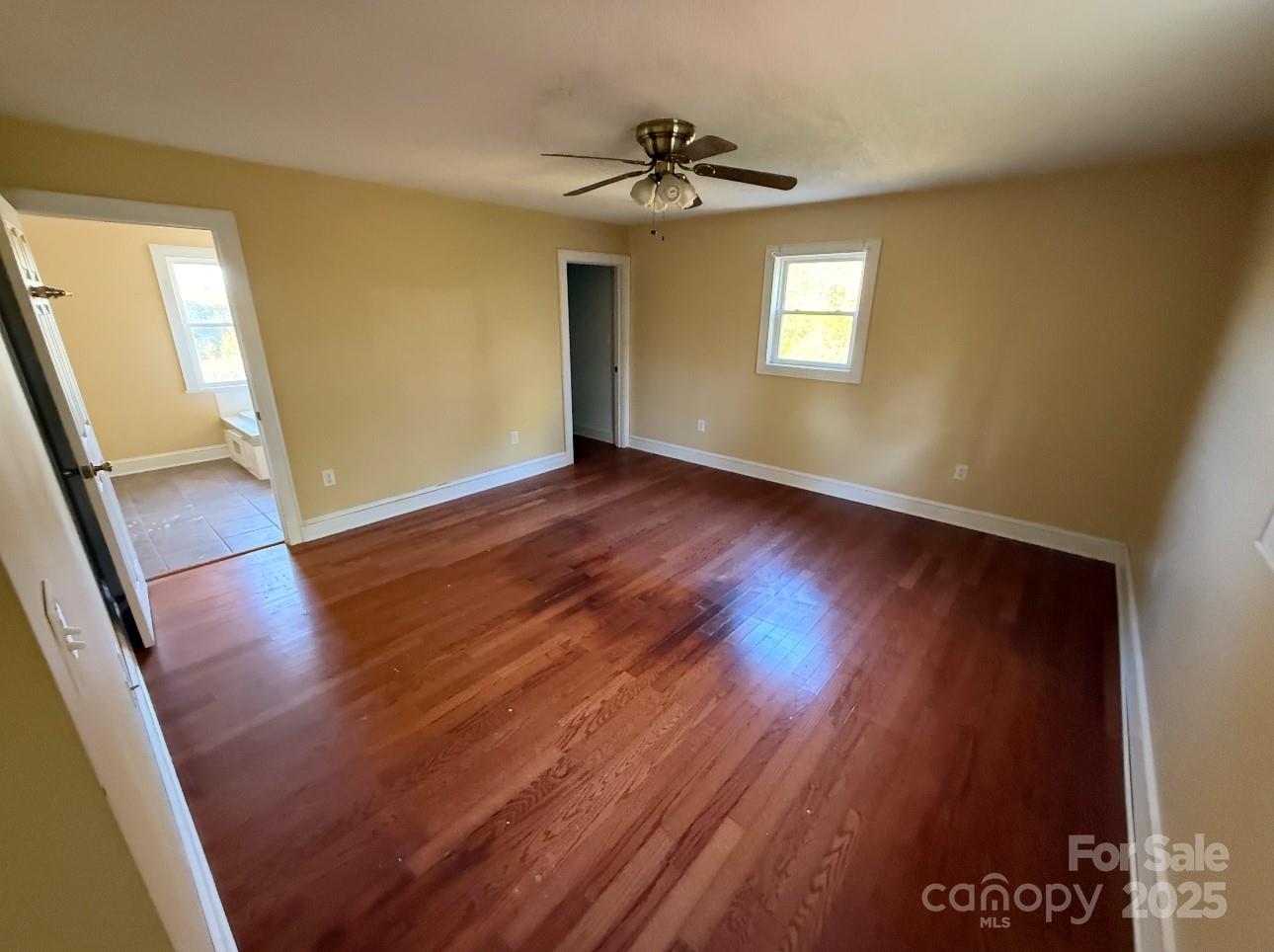 1088 Ramie Mitchell Road Hiddenite, NC 28636 - Photo 11 of 16 a view of an empty room with wooden floor and a window