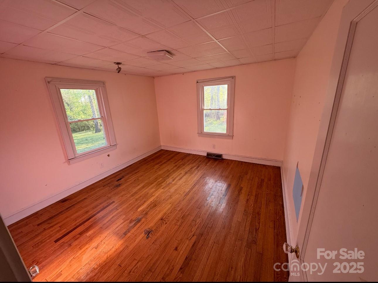 1088 Ramie Mitchell Road Hiddenite, NC 28636 - Photo 12 of 16 a view of an empty room with wooden floor and a window