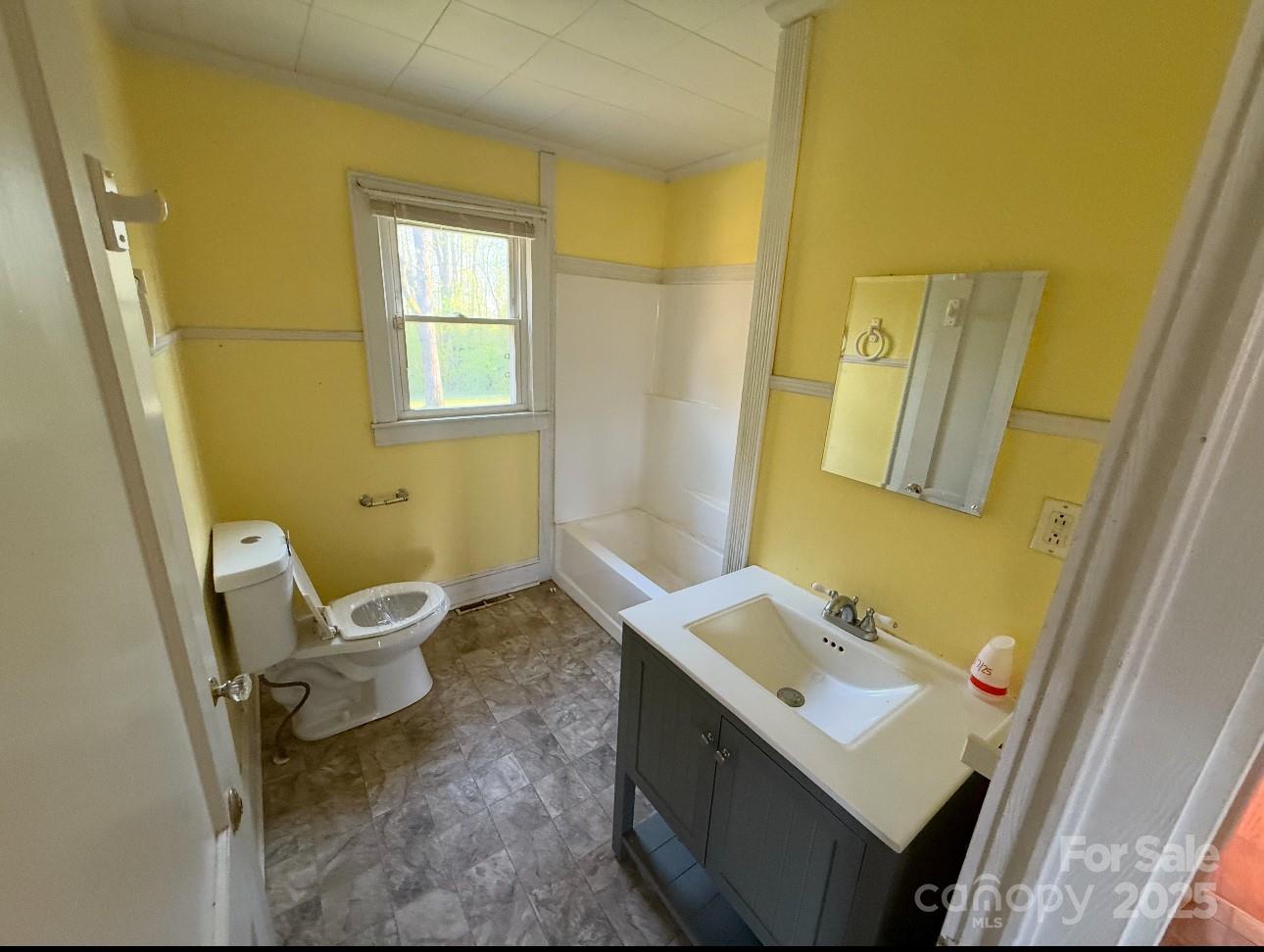 1088 Ramie Mitchell Road Hiddenite, NC 28636 - Photo 13 of 16 a bathroom with a sink mirror and toilet