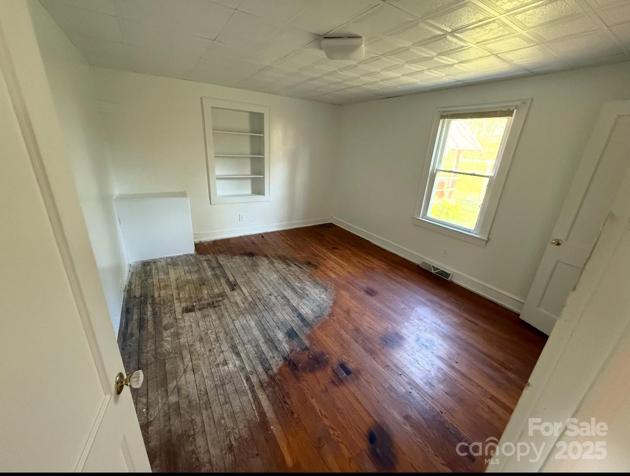1088 Ramie Mitchell Road Hiddenite, NC 28636 - Photo 15 of 16 a view of empty room with wooden floor and fan