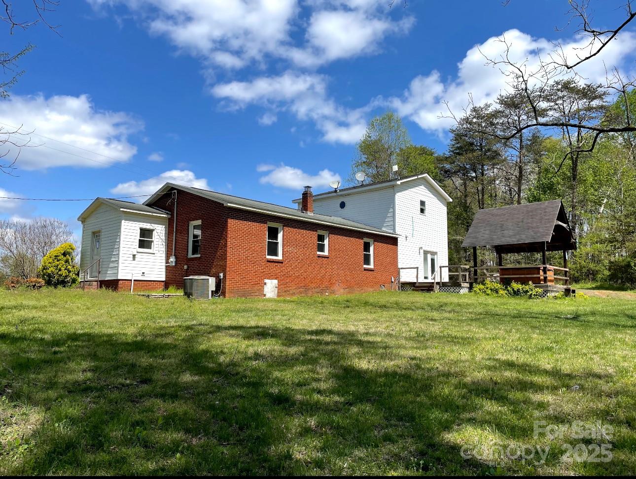 1088 Ramie Mitchell Road Hiddenite, NC 28636 - Photo 2 of 16 a front view of a house with a garden and yard