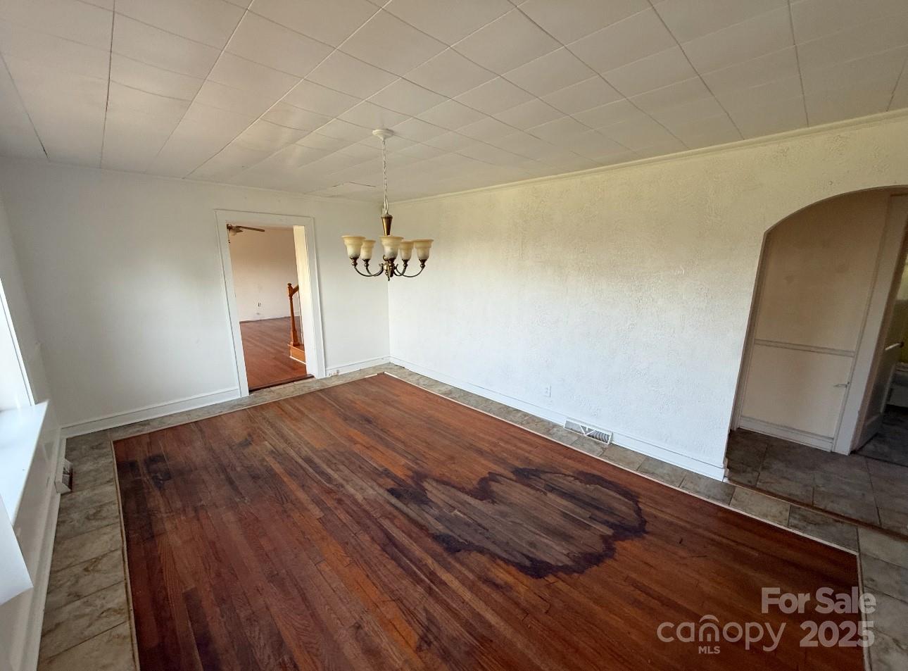 1088 Ramie Mitchell Road Hiddenite, NC 28636 - Photo 5 of 16 a bedroom with a bed and wooden floor