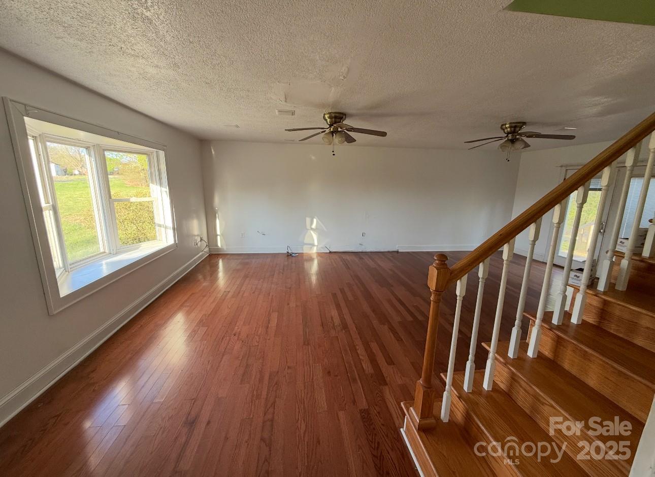 1088 Ramie Mitchell Road Hiddenite, NC 28636 - Photo 6 of 16 wooden floor in an empty room with a window