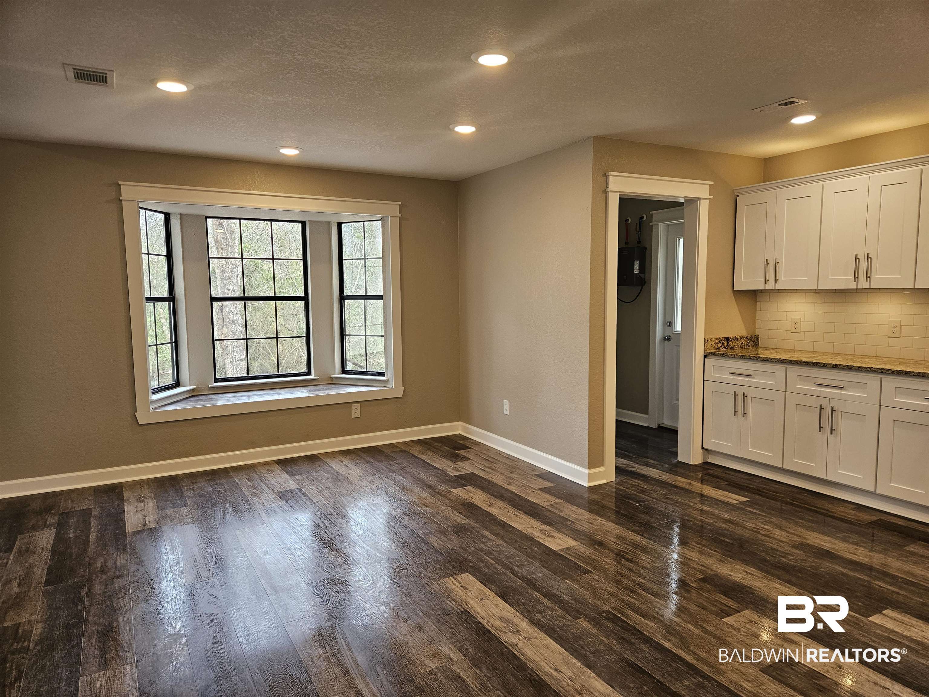 138 Wicker Way Daphne, AL 36526 - Photo 7 of 32 Unfurnished living room with dark wood-type flooring, recessed lighting, and a textured ceiling