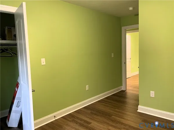 a view of a room with wooden floor and fan
