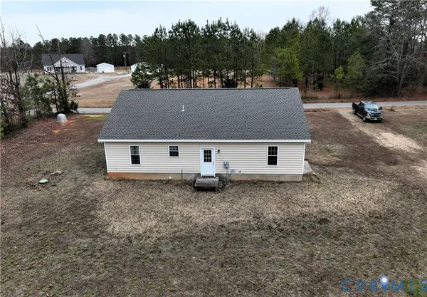 an aerial view of a house with yard